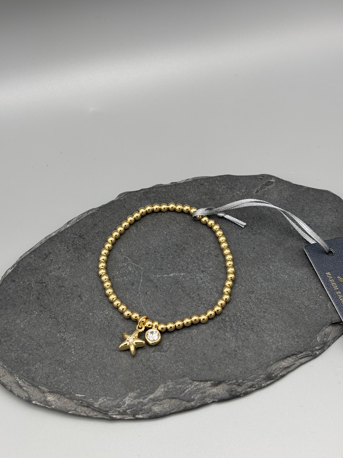 Karen Sampson gold bracelet with hanging charms