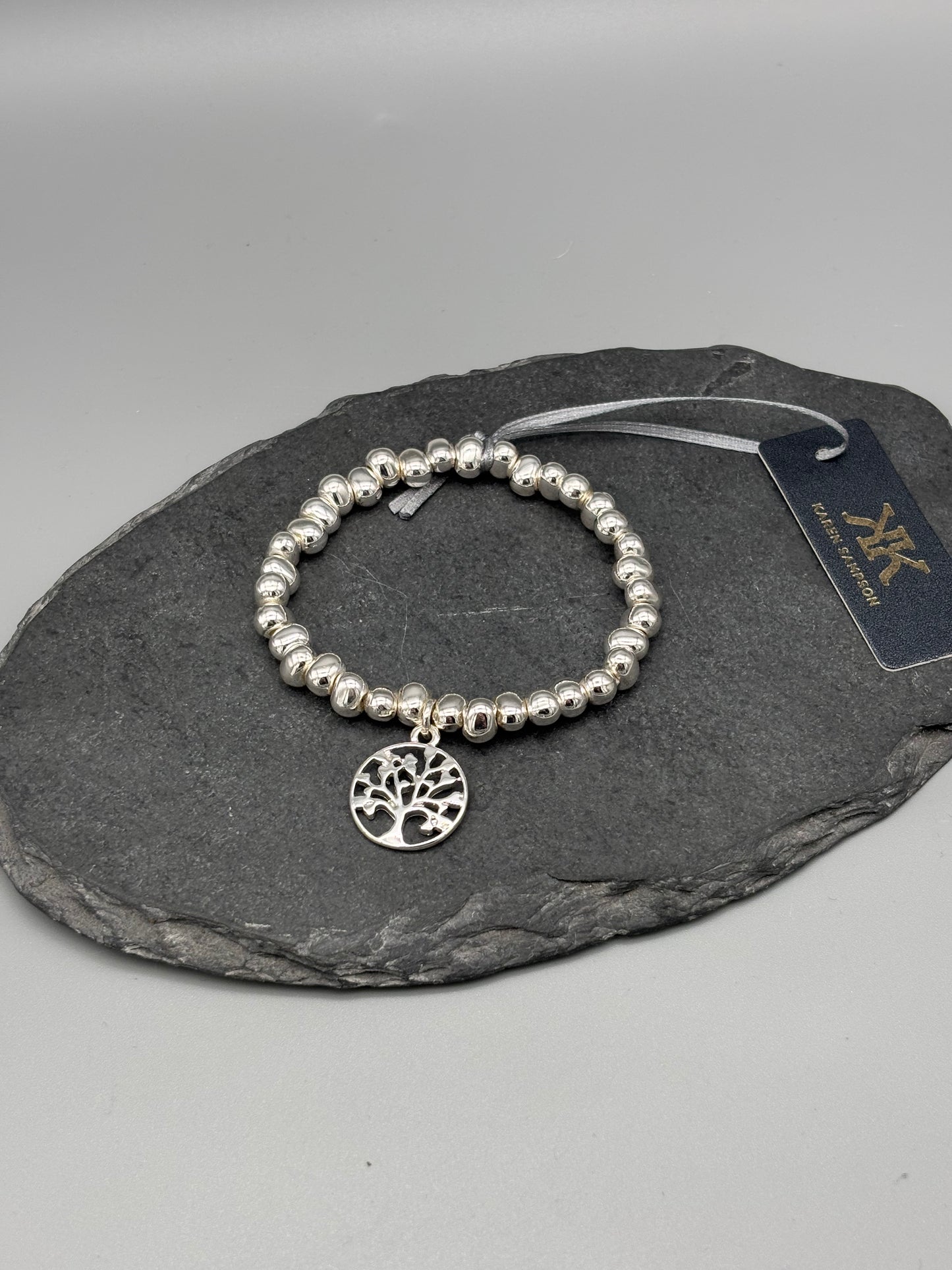 Karen Sampson silver bracelet with free of life charm